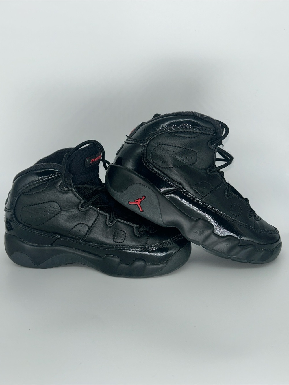 Jordan Kids Black High-Top Sneakers with Red Jumpman Accent